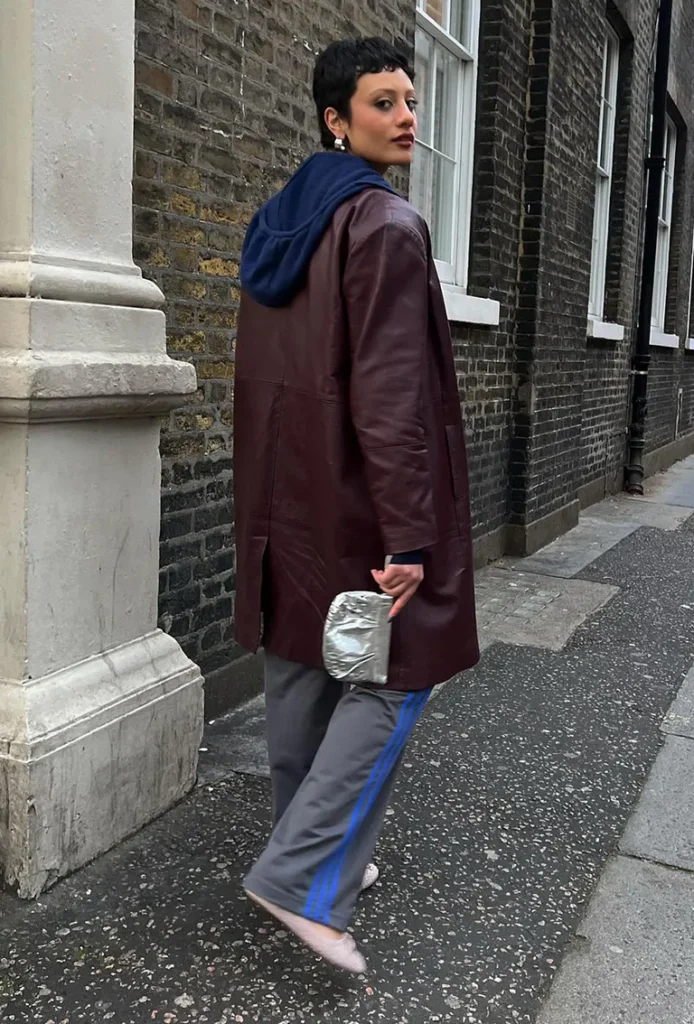 Hoops hoodie, leather jacket, track pants, sneakers, clutch.